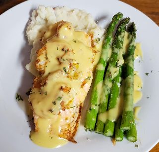 Seafood - Seafood Stuffed Flounder or pan seared Salmon over mashed potatoes with asparagus, drizzled with hollandaise sauce along with a trip to the salad bar!